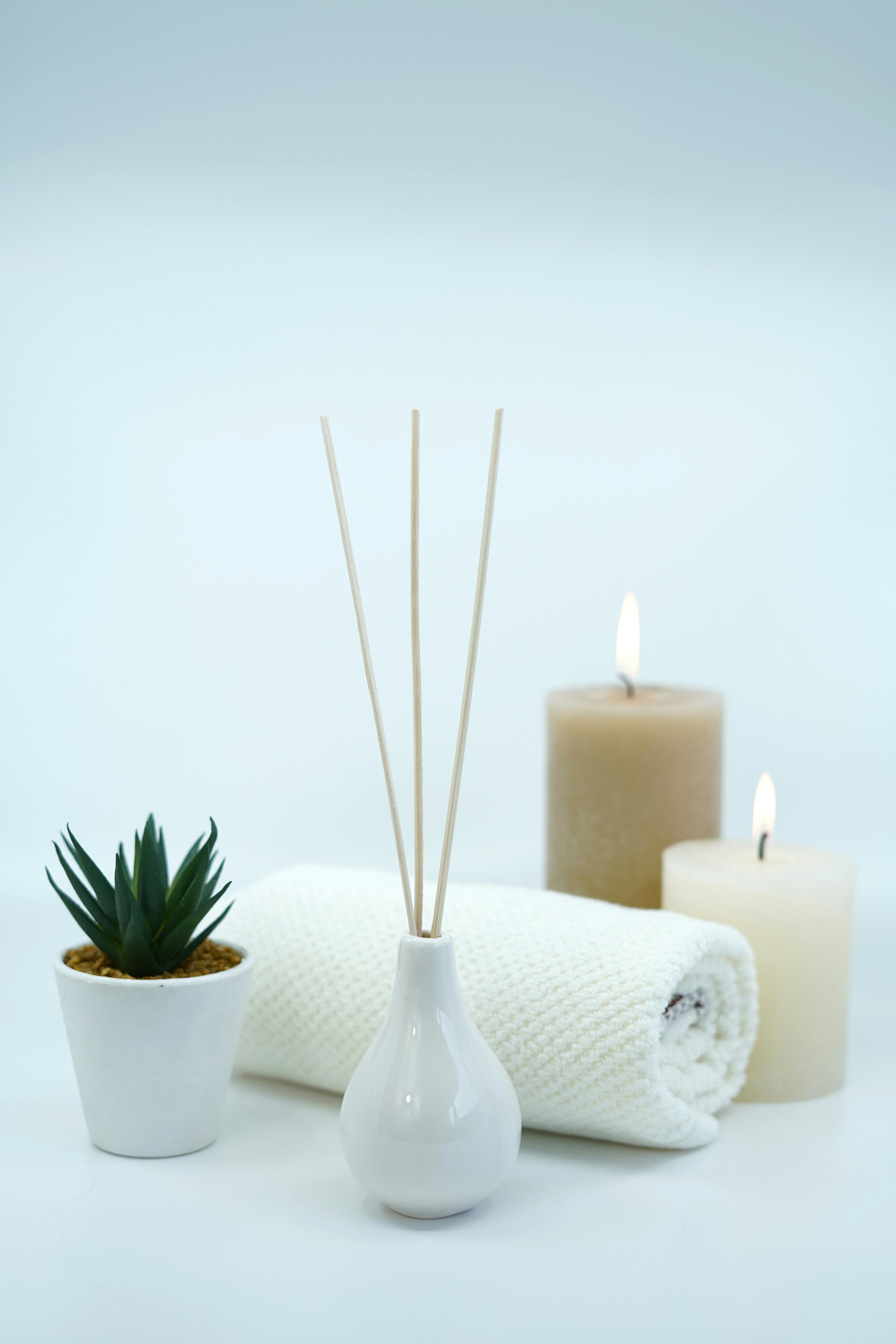 Candles, towel and diffuser spa ambience